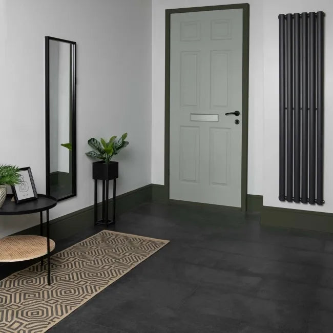 Modern hallway with Stone Effect Anthracite LVT floor, pale green door, black radiator and contemporary décor