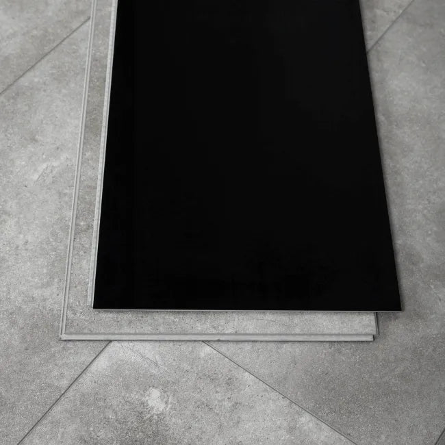 Close-up of Stone Effect Grey LVT with waterproof SPC construction, built-in underlay and black surface layer detail.