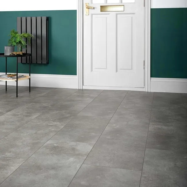 Stone Effect Grey LVT floor fitted in a modern hallway with white door, teal wall panelling and contemporary décor.