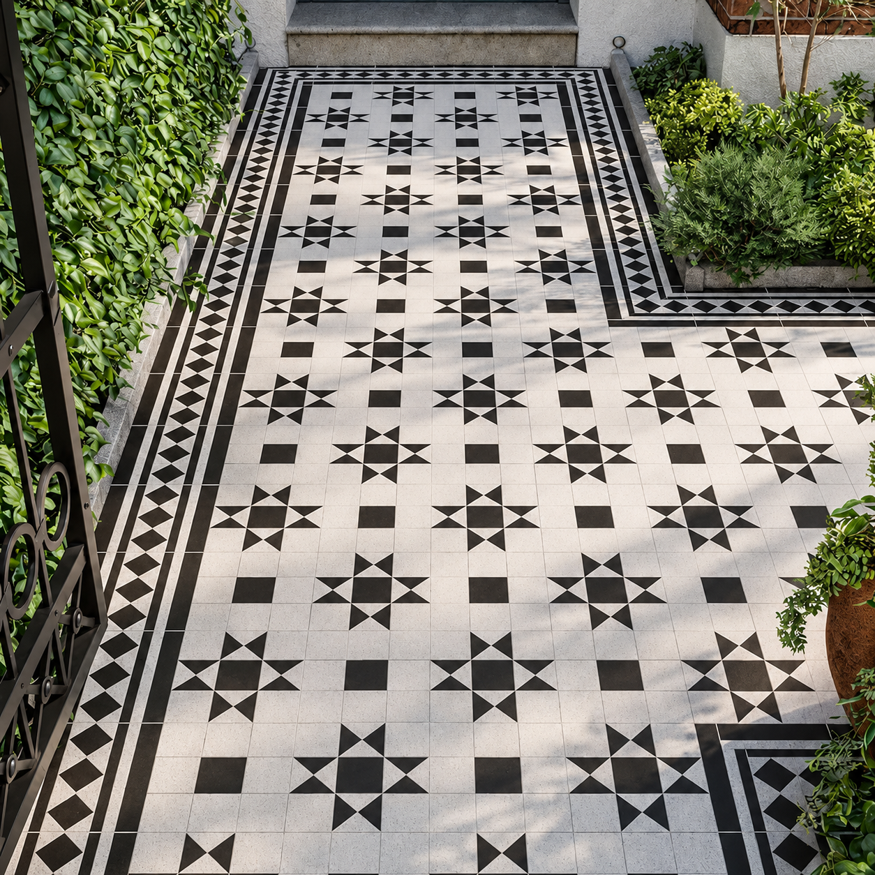 Dorset black and white star-pattern porcelain floor tiles with diamond borders on a planted garden entrance path