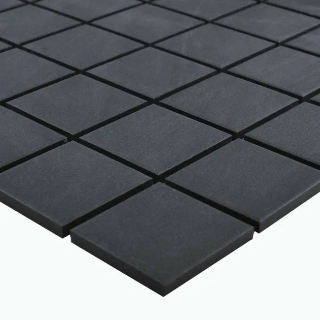 Square black mosaic tile sheet showing precise joint spacing and texture