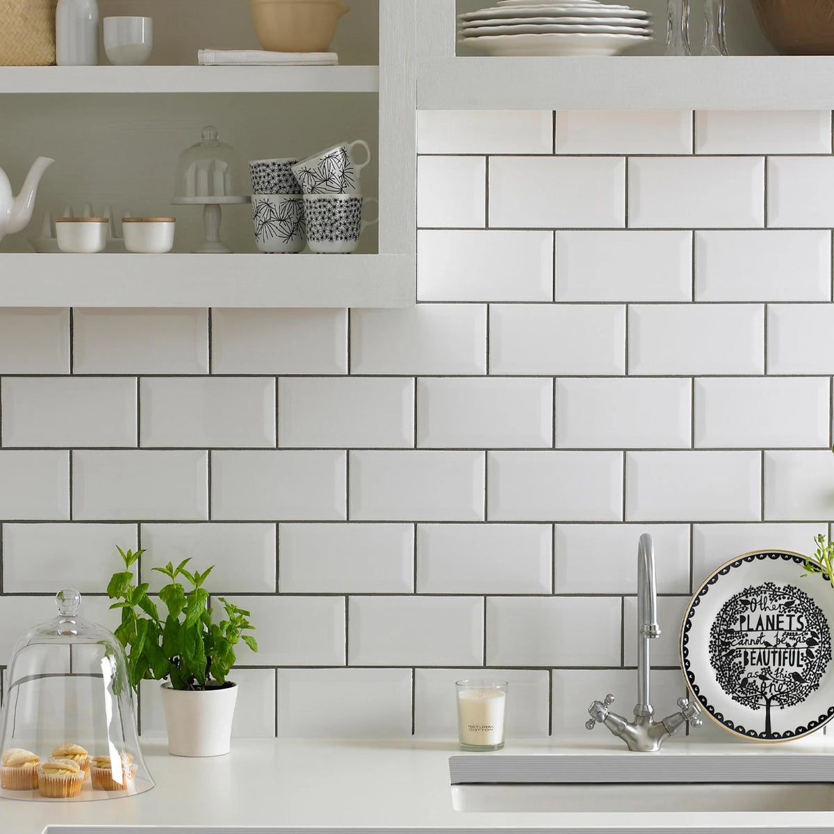 White gloss bevelled metro wall tiles in classic kitchen splashback with contrasting dark grout and open shelving