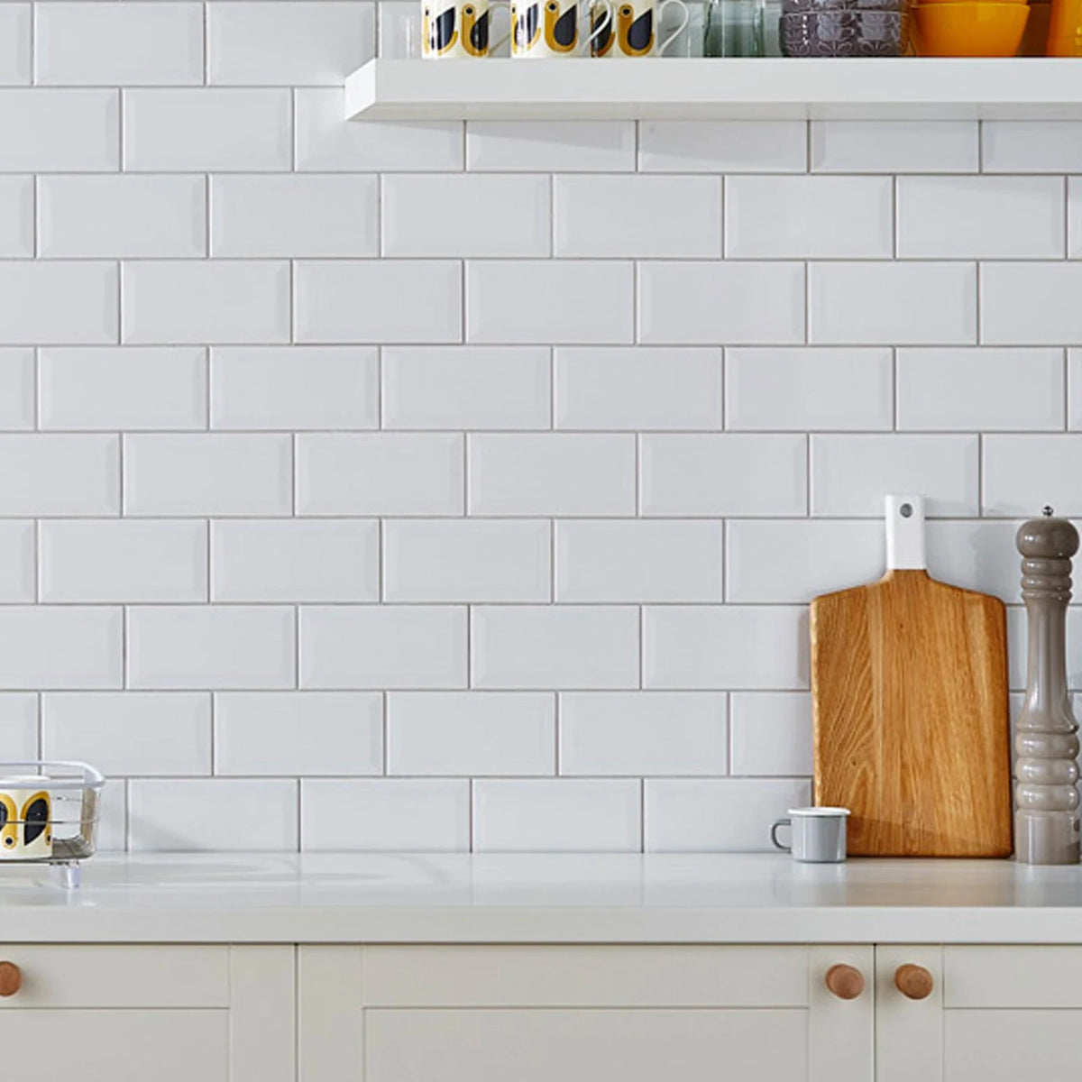 Classico Blanco White Metro ceramic wall tiles in brick bond layout with white kitchen cabinets and wooden accessories