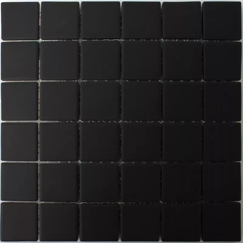 Square black mosaic tile sheet showing precise joint spacing and texture